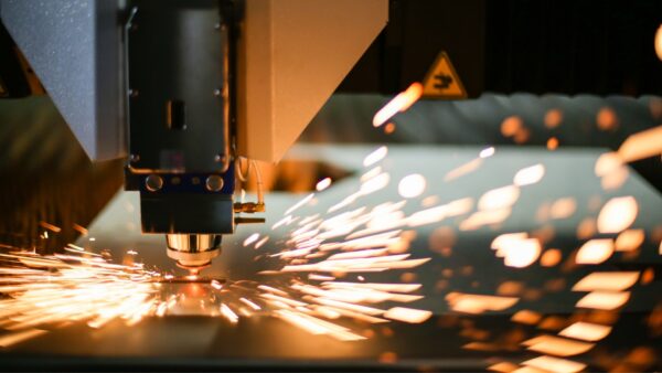 Close up image of a CNC machine working with sparks flying