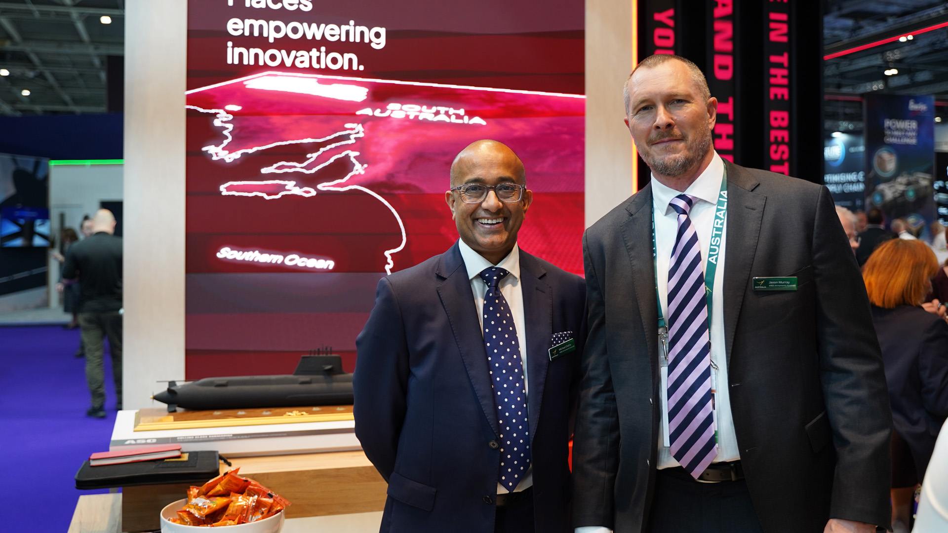 Two people from Ares South Australian standing at the Defence State Stand