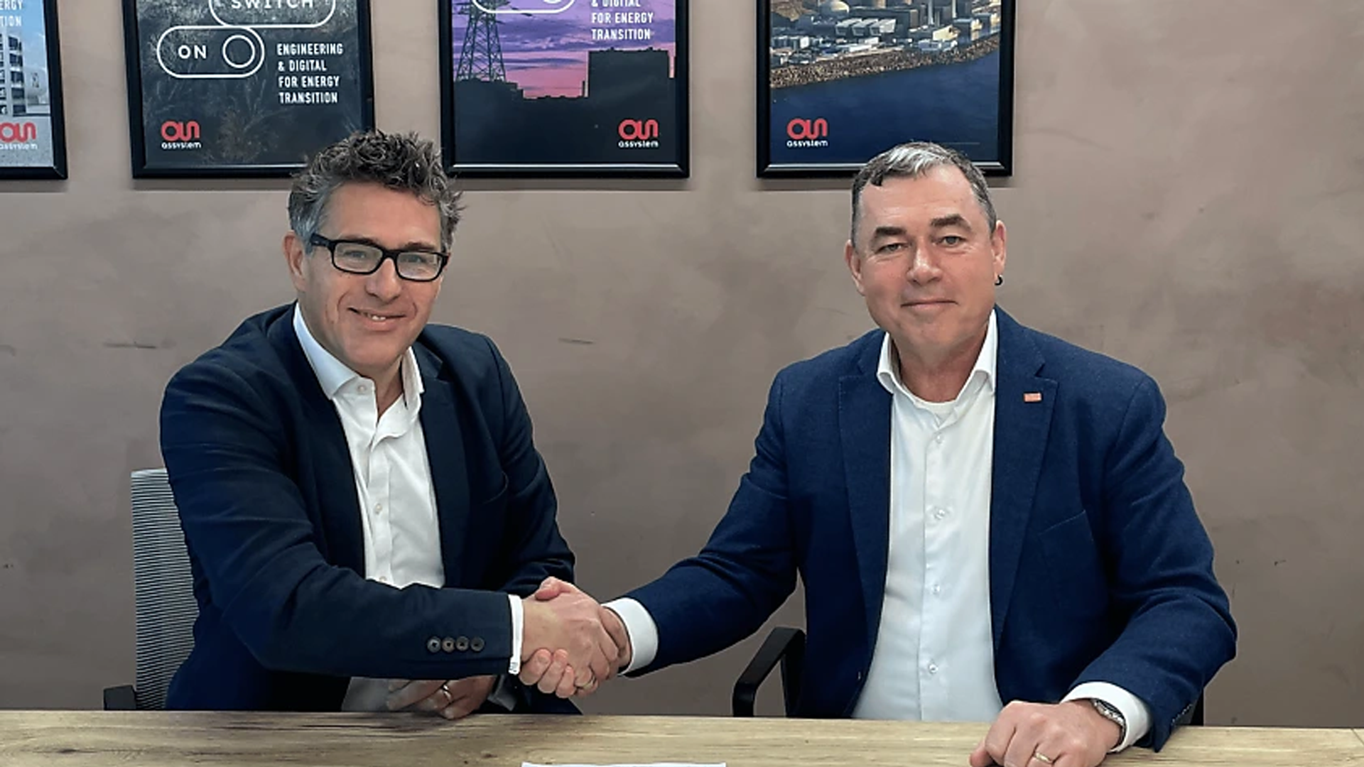 Two representatives from Shoal Group and Assystem following their partnership signing.