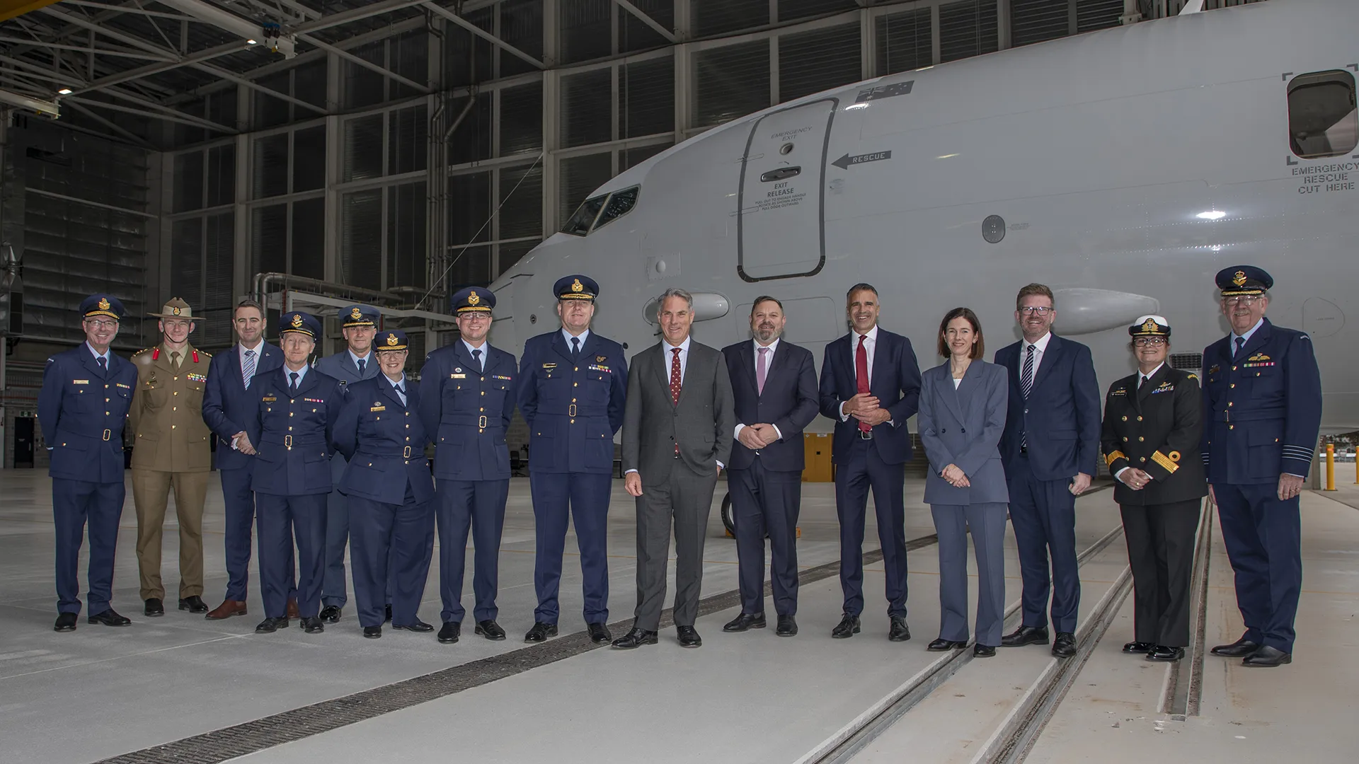 Deputy Prime Minister and Minister for Defence, the Hon. Richard Marles, MP, and Head of Aerospace systems Division, Vice-Marshal Gerry van Leeuwin, AM, CSM, stand in a group photo with all the leaders with an interest in the Deep Maintenance and Modification Facility Opening held at RAAF Base Edinburgh