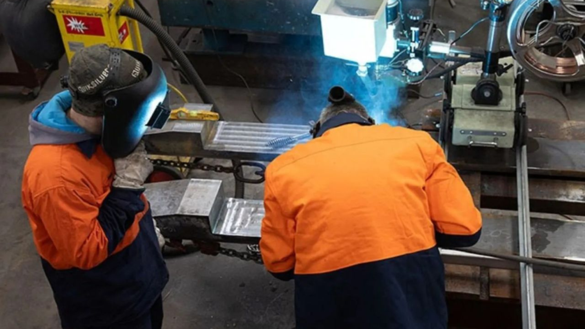 Two wielders in high vis uniforms